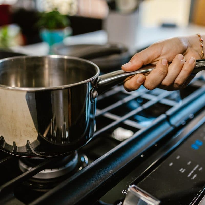 A stainless steel saucepan on a stovetop. Illustrative stock photograph, not a photograph of the reviewed pan.