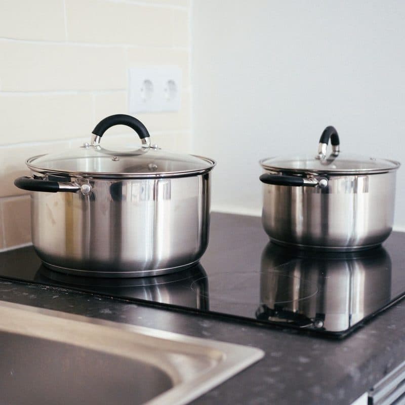 Two stainless steel pots on a cooktop. Illustrative stock photograph, not a photograph of the reviewed set.