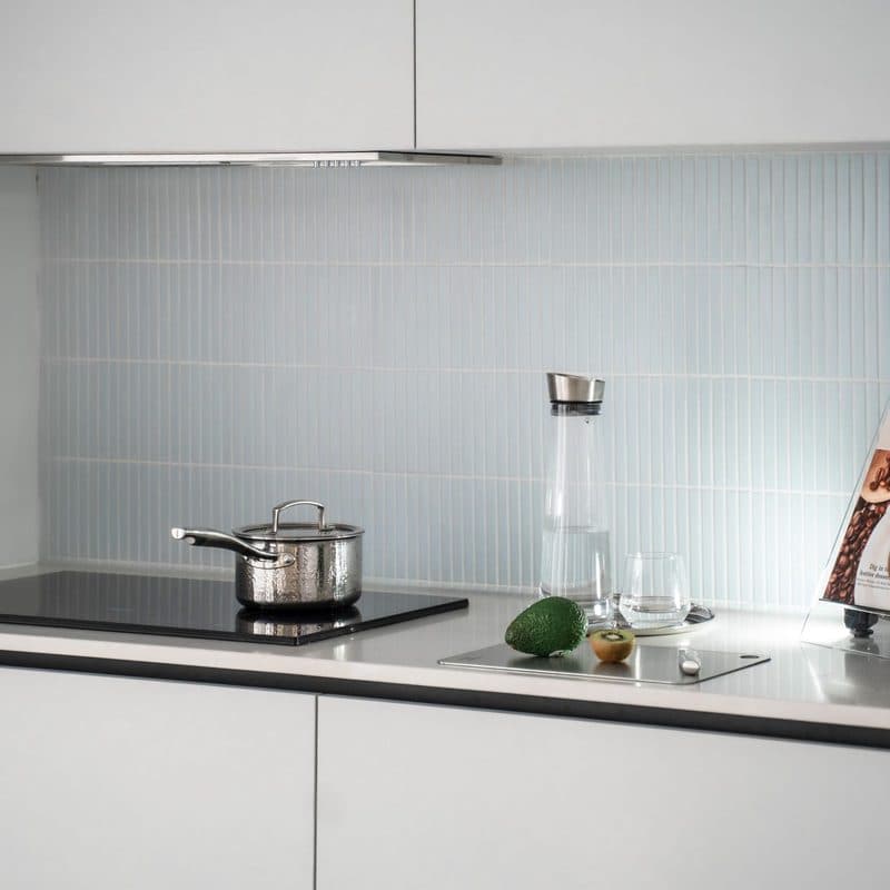 A stainless steel pot with a lid on an induction hob. Illustrative stock photograph, not a photograph of the reviewed pot.