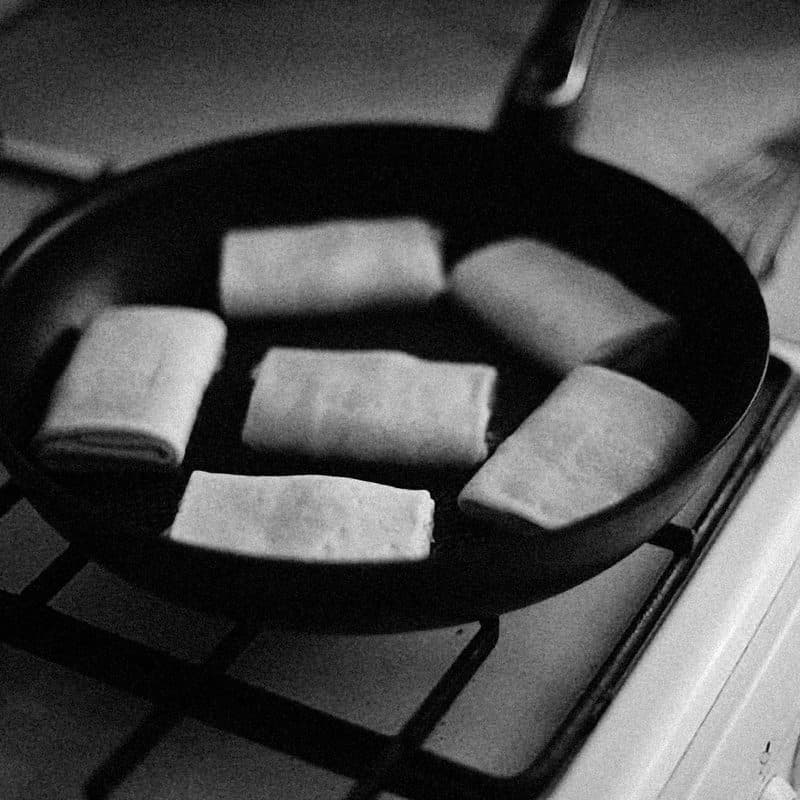 Food cooking in a stainless steel frying pan. Illustrative stock photograph, not a photograph of the reviewed pan.