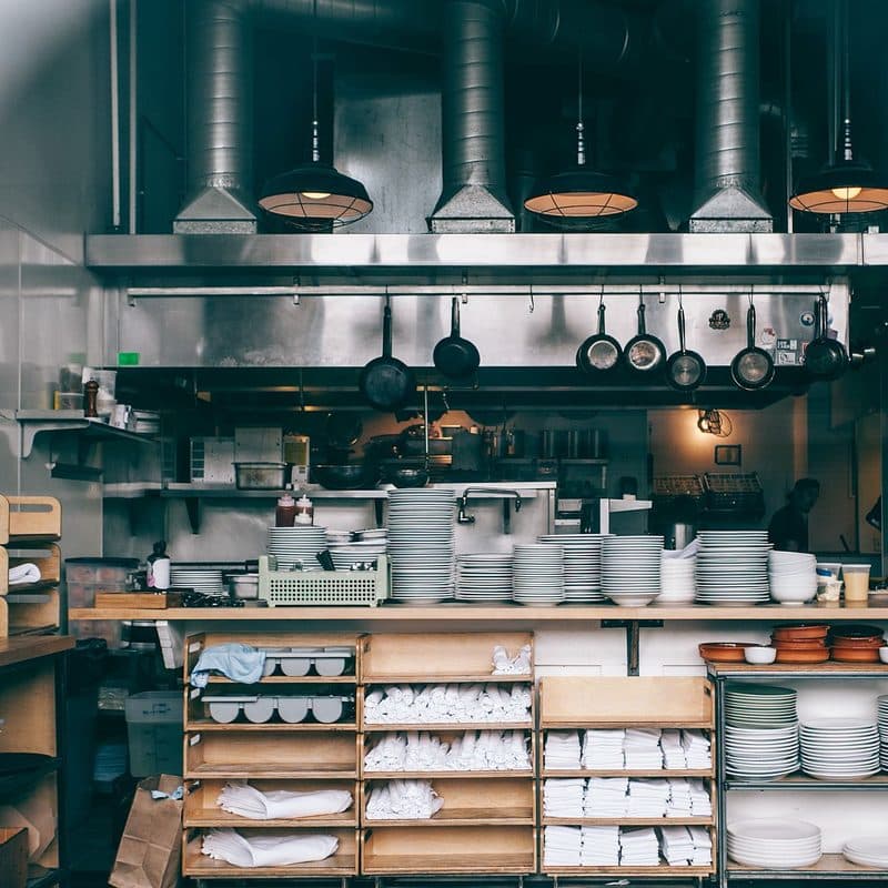 A stack of stainless steel pots and pans. Illustrative stock photograph, not a photograph of the reviewed set.