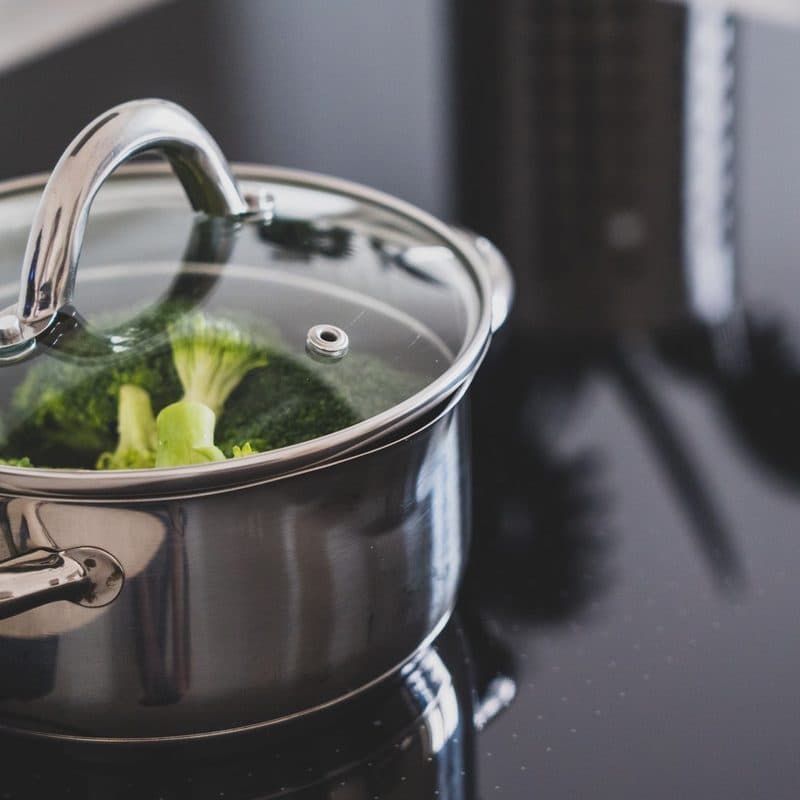 Broccoli cooking in a stainless steel pot. Illustrative stock photograph, not a photograph of the reviewed pot.