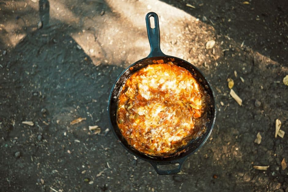 Food cooking in a cast iron skillet.