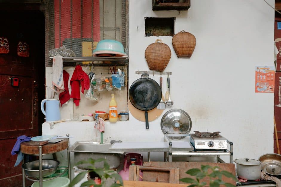 A collection of well-used cooking pots and utensils.