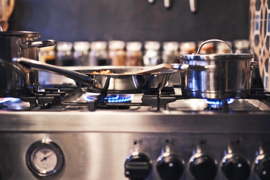 A blue gas flame beneath a cooking pot.