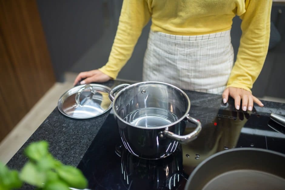 A steel pot heating on an induction cooktop.